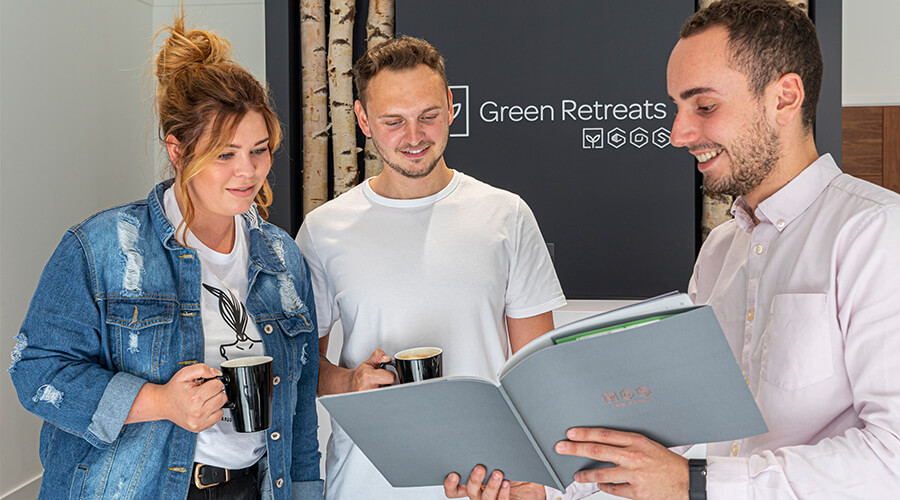 design consultant showing customers through brochure