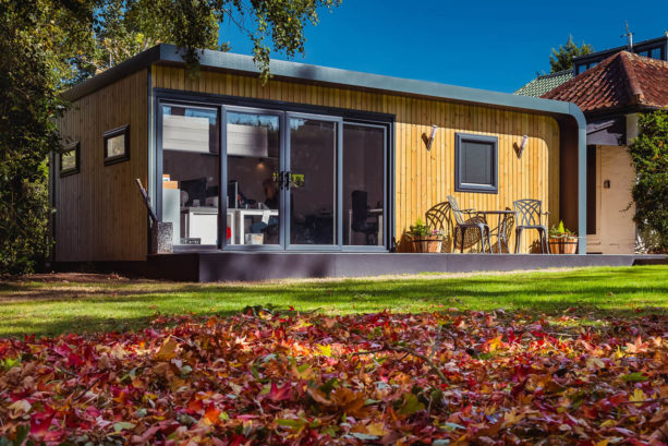 Exterior of garden office with fallen autumn leaves